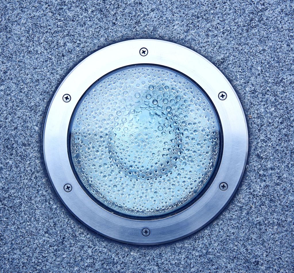 Recessed in-ground LED light installed flush with paved surfaces.jpg